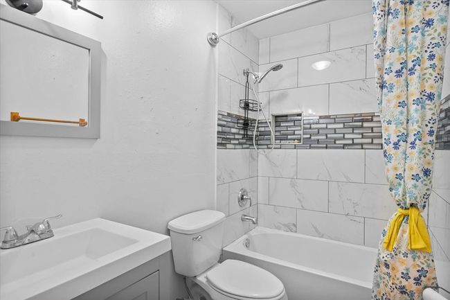 Full bath featuring toilet, shower / tub combo, and vanity | Image 10