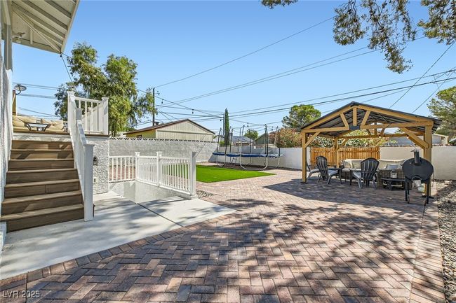 View of patio / terrace with a trampoline, a gazebo, and stairs | Image 26