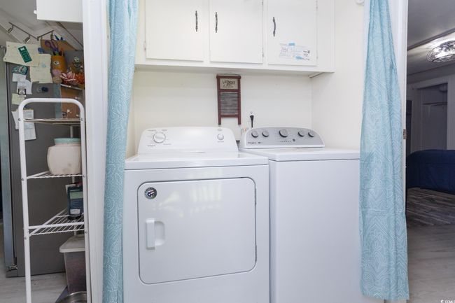 Laundry area with washer and dryer, cabinet space, and wood finished floors | Image 29