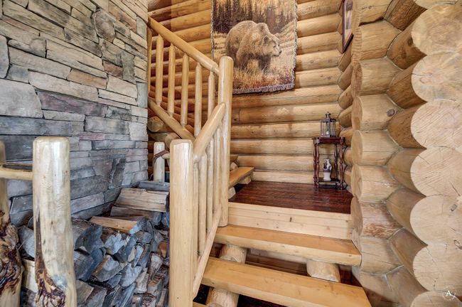 Staircase featuring log walls | Image 23