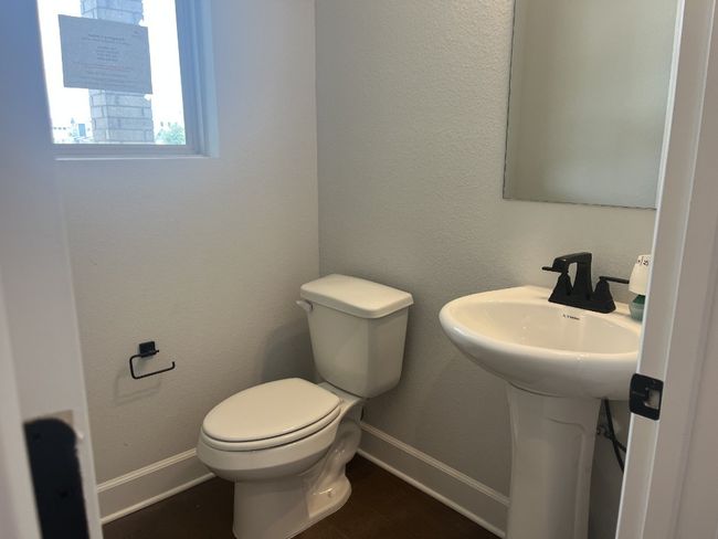 Bathroom featuring toilet, baseboards, and a sink | Image 25