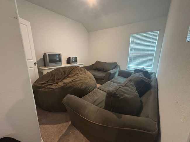 Living room featuring carpet floors and lofted ceiling | Image 21
