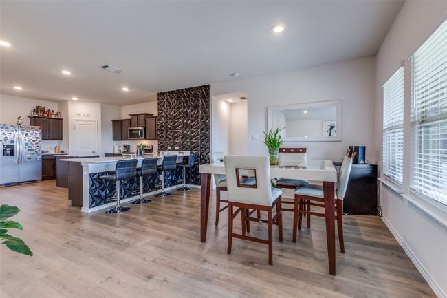 Dining area featuring light wood-type flooring, recessed lighting, baseboards, and visible vents | Image 11