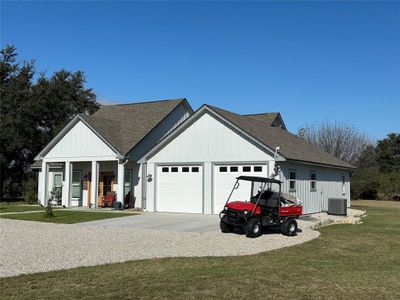 View of front facade with a front lawn and a garage | Image 2