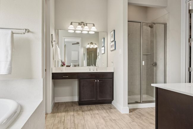 Bathroom with vanity, a shower stall, a bath, and wood finished floors | Image 21