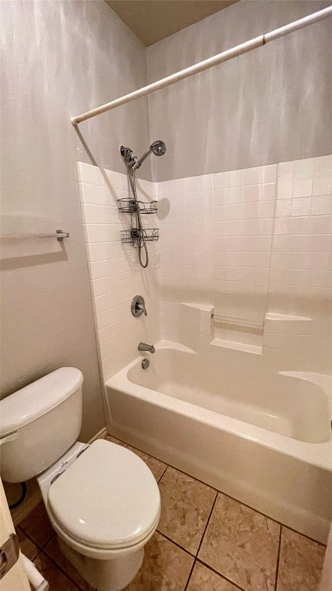 Bathroom featuring shower / tub combination and tile patterned floors | Image 29