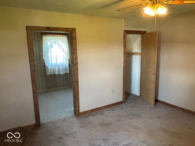 unfurnished bedroom with carpet, baseboards, and ceiling fan | Image 18