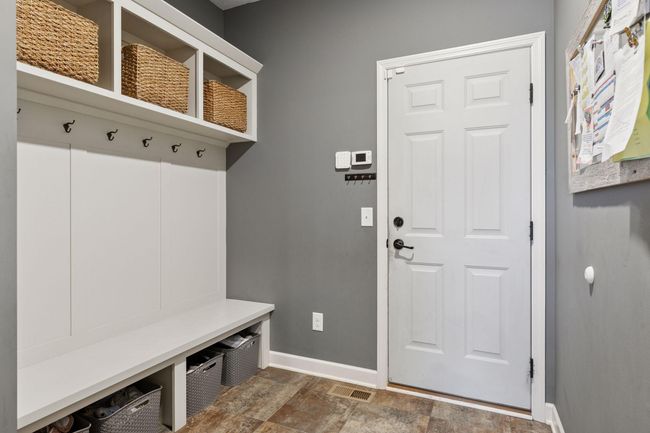 Mudroom with bench and cubbies. Kitchen pantry and large coat closet are adjacent to this space. | Image 15