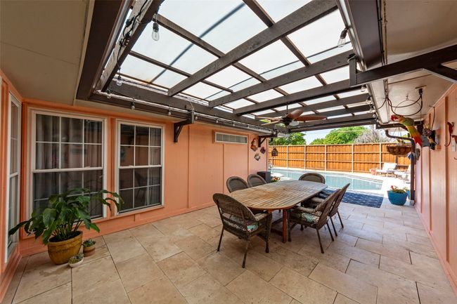 View of patio / terrace with a pergola, outdoor dining space, a fenced in pool, and fence | Image 7