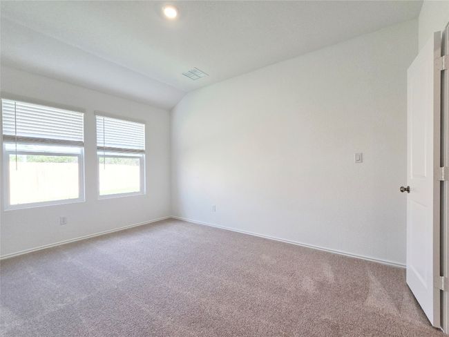 Empty room featuring carpet floors, baseboards, and vaulted ceiling | Image 27
