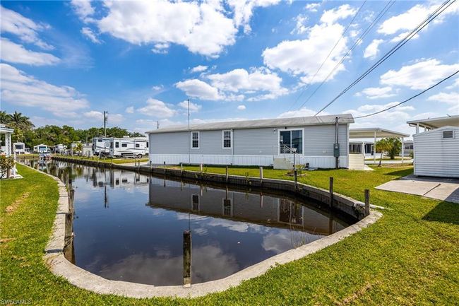 Rear view of house with a water view and a lawn | Image 30