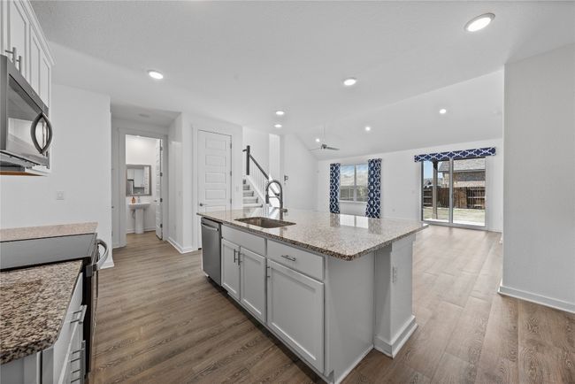 Kitchen with recessed lighting, a sink, stainless steel dishwasher, and wood finished floors | Image 17