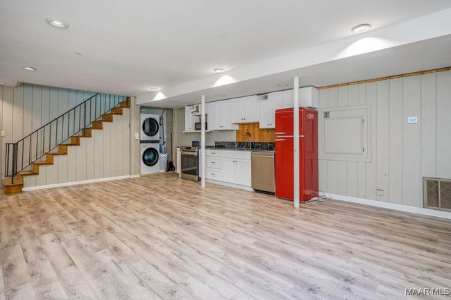 Refrigerator and stacked washer and dryer remain. There's plenty of room for a combined living room and dining area. So private! | Image 66