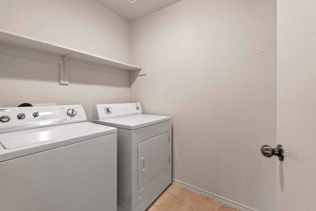 The 2nd floor laundry room is equipped with a Washer and Dryer and overhead shelf space for your laundry needs. | Image 24