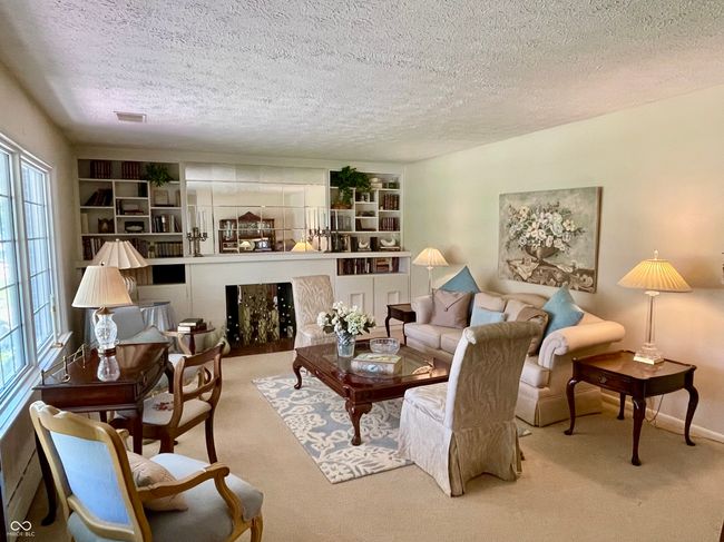 Family room with wood burning fireplace and built in shelves | Image 19