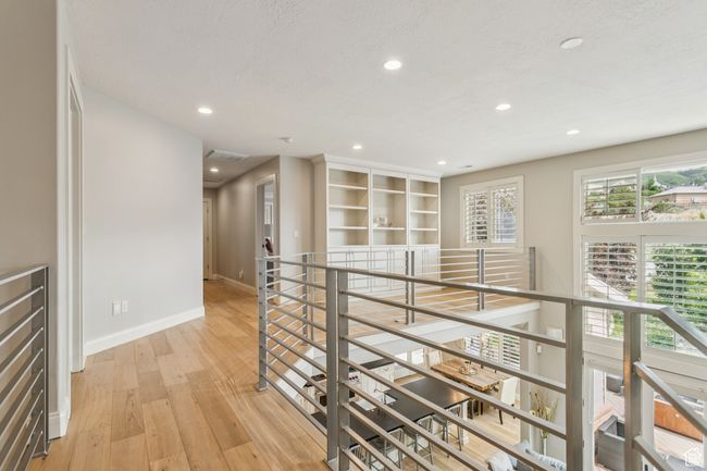 Hallway with light wood-style floors, recessed lighting, and an upstairs landing | Image 35