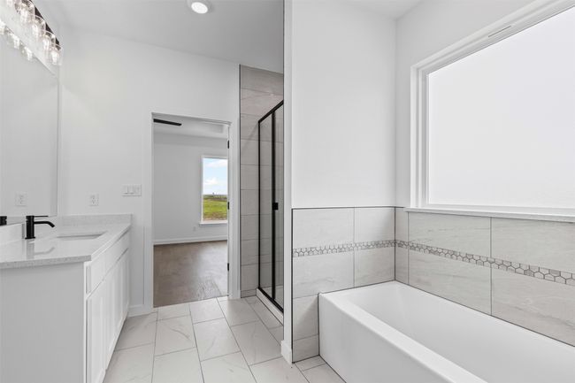 Bathroom with a sink, marble finish floor, a bath, and a healthy amount of sunlight | Image 25