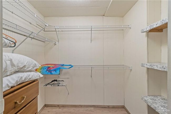 Walk in closet with light wood finished floors | Image 14