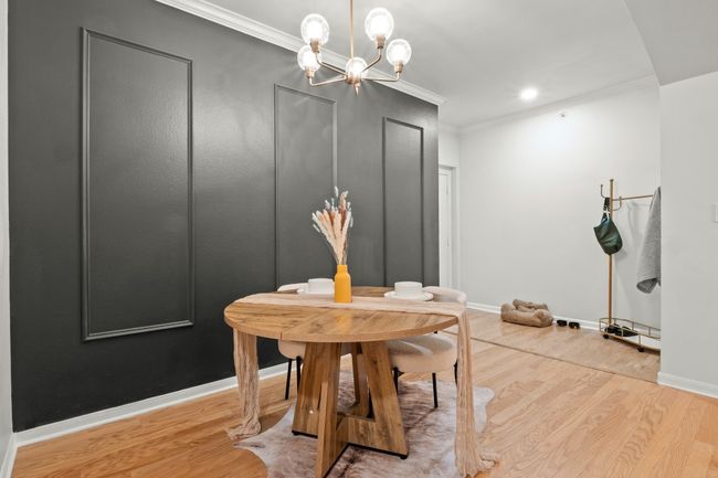 Dining room featuring a notable chandelier, crown molding, recessed lighting, light wood-type flooring, and baseboards | Image 4