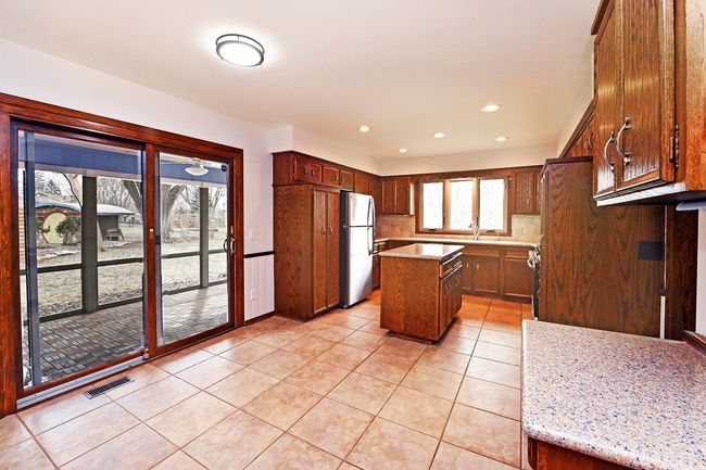 Freshly Painted Large Updated Kitchen Features Center Island, Loads of Storage with Screen Porch through Sliders. All Appliances Stay! | Image 22
