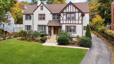 English style home with a front lawn | Image 3