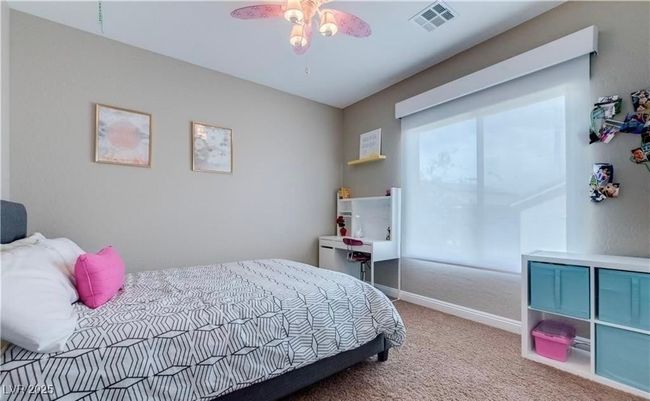 Carpeted bedroom with baseboards, ceiling fan, and visible vents | Image 10