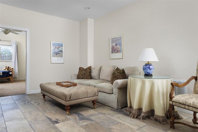 Living area with baseboards and light stone finish flooring | Image 33