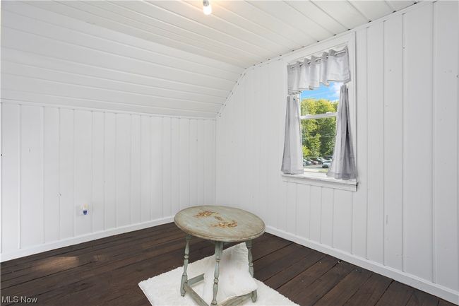 Additional living space with dark hardwood floors and lofted ceiling | Image 21