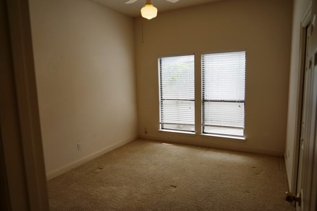 Carpeted spare room featuring ceiling fan and baseboards | Image 17