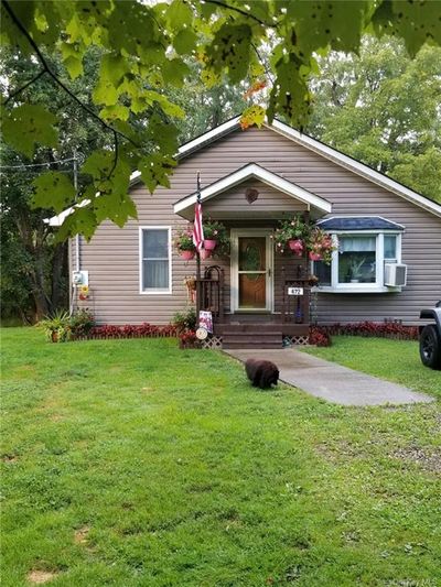 View of front of property with cooling unit and a front lawn | Image 1