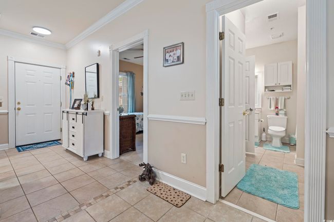 Entryway with light tile patterned flooring and ornamental molding | Image 14