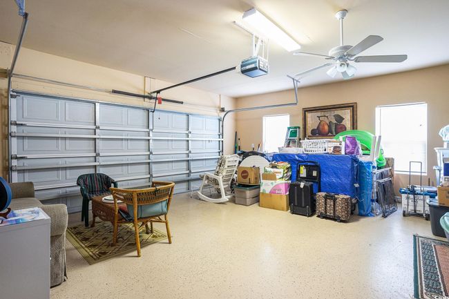 Garage featuring a garage door opener and ceiling fan | Image 25