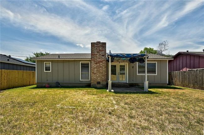 Back of property featuring board and batten siding, french doors, and a chimney | Image 24