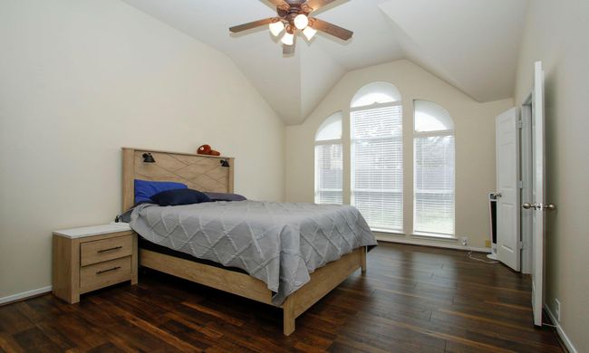 The primary bedroom has an elevated ceiling and no carpeting. Lots of room in the primary. | Image 10