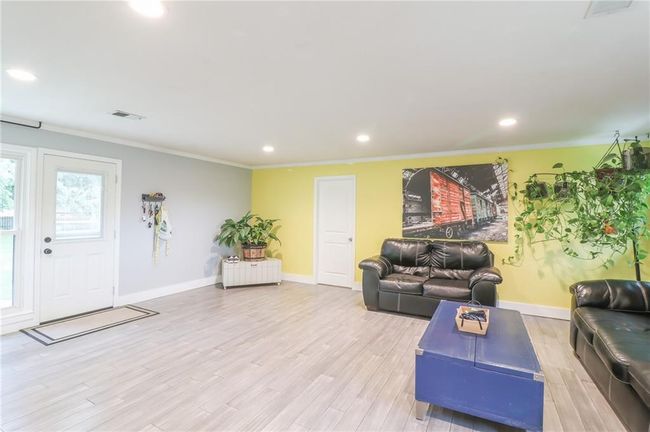 Living room featuring recessed lighting, light wood-style floors, and crown molding | Image 16