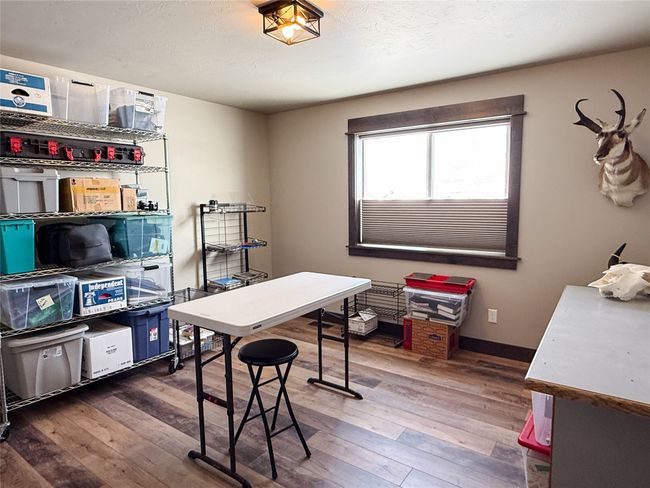 Office space with a textured ceiling, baseboards, and wood finished floors | Image 33