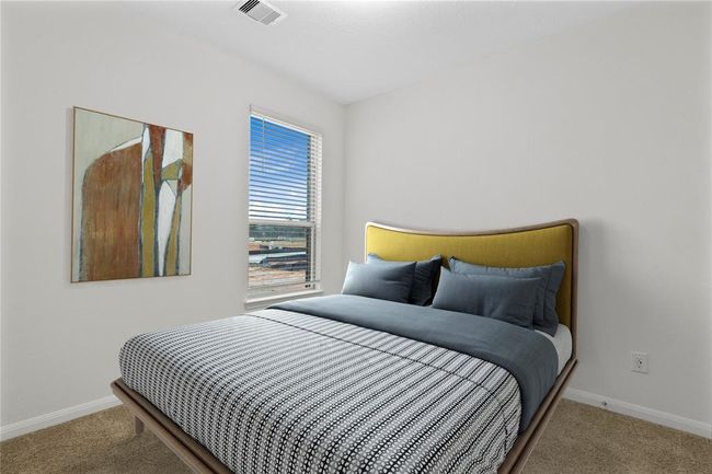 Secondary bedroom features plush carpet, high ceiling and a large window with privacy blinds. | Image 5