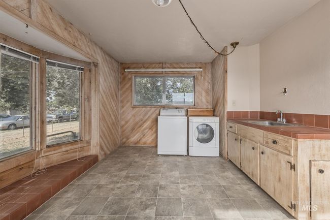 Laundry room with independent washer and dryer, cabinet space, and wood walls | Image 19