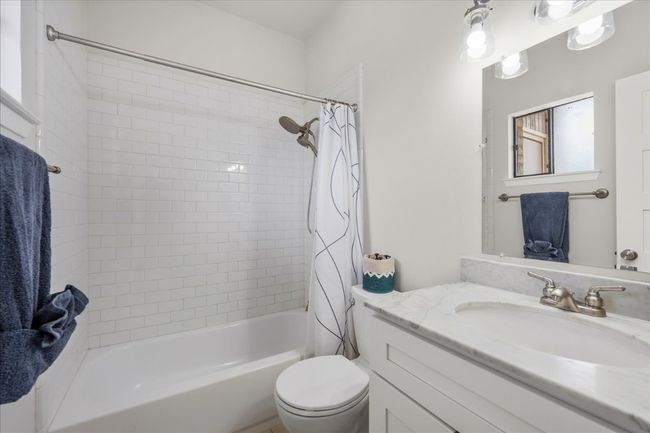 Full bathroom featuring vanity and shower / bathtub combination with curtain | Image 24
