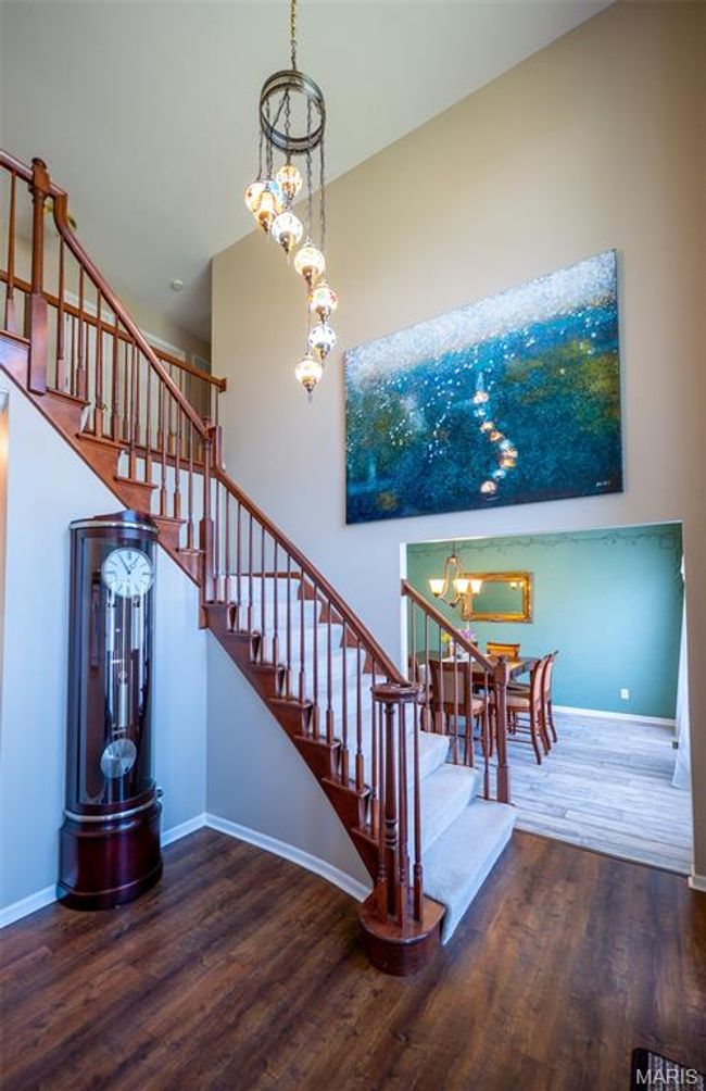 Stairs featuring a chandelier and wood finished floors | Image 24