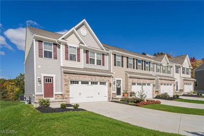 View of front of property featuring a front yard, a garage, and central AC unit | Image 2