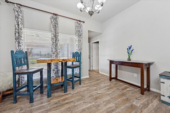Bright and inviting dining space conveniently located off the kitchen, featuring large windows for natural light. | Image 11