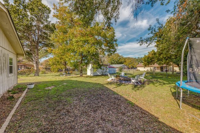 View of yard with a trampoline and a storage shed | Image 23