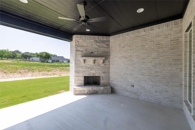 View of patio / terrace with ceiling fan and an outdoor stone fireplace | Image 34
