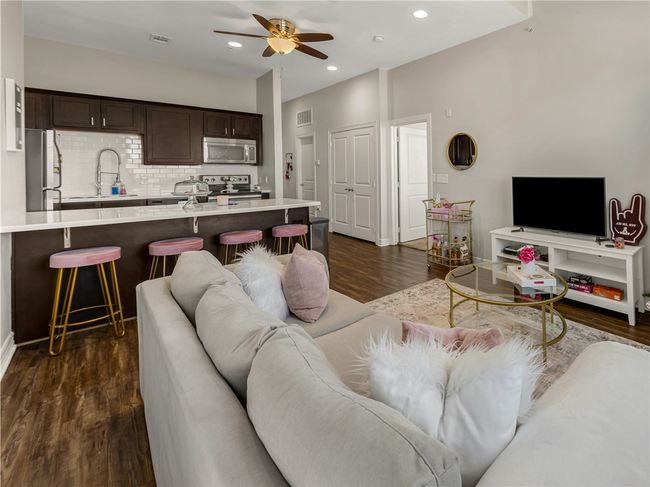 Living room featuring dark hardwood / wood-style flooring, sink, and ceiling fan | Image 20