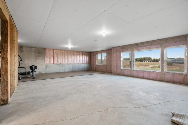 The unfinished walkout lower level is plumbed for a bathroom and ready for your personal touch, perfect for additional living space or storage. | Image 25
