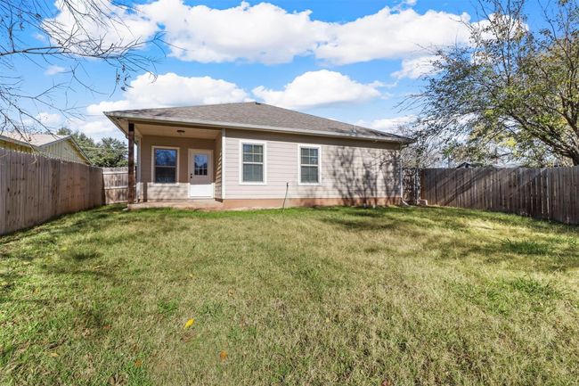 Rear view of house with a fenced backyard | Image 15