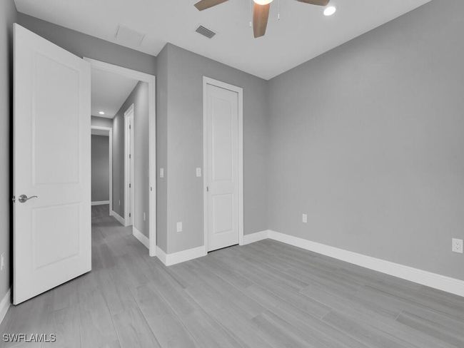Unfurnished bedroom featuring wood finished floors, recessed lighting, ceiling fan, and a closet | Image 29