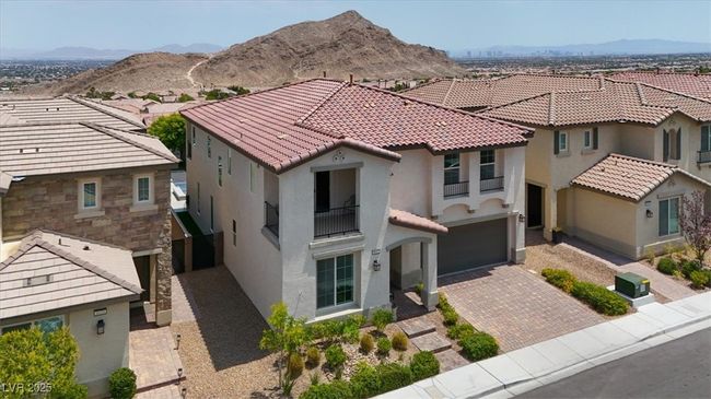 Mediterranean / spanish-style home with stucco siding, driveway, a residential view, a mountain view, and a garage | Image 62