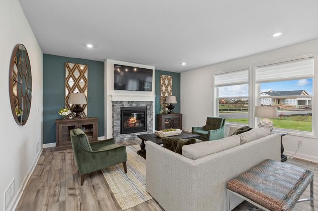 Photo is of the actual model. This modern fireplace with natural stone surround is an extraordinary room accent. Enjoy the warmth of this gas fireplace as you relax in your living room. | Image 7